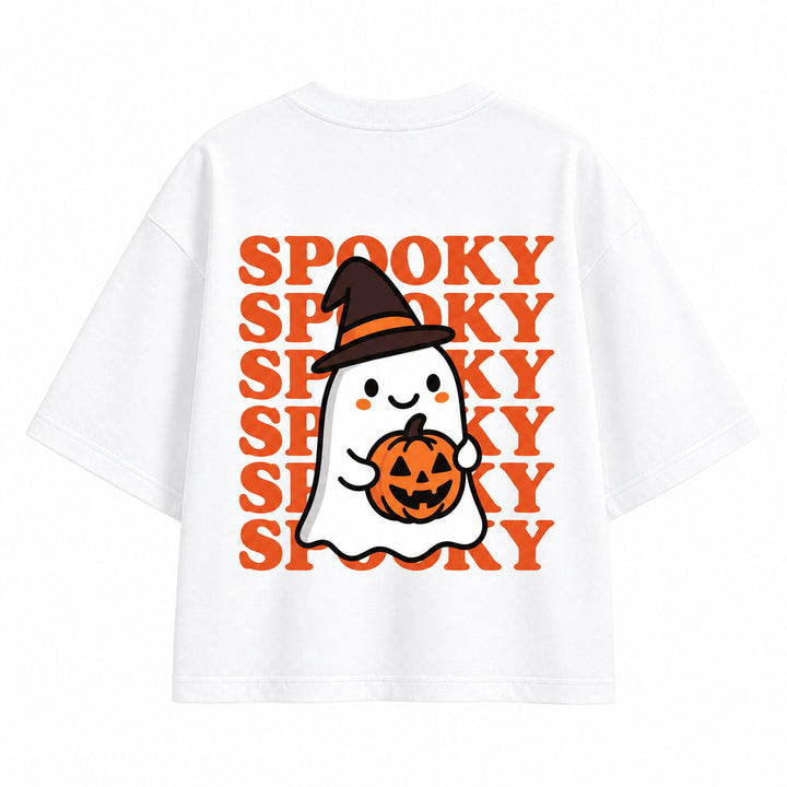 White short-sleeve T-shirt with a Halloween graphic featuring a cartoon ghost holding an orange pumpkin, set against a repeating orange 'SPOOKY' text pattern, shown on a solid gray background.
