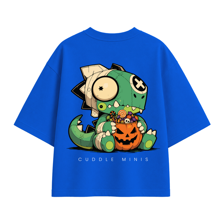 A bright blue short-sleeve T-shirt with a large cartoon dinosaur graphic on the front, holding a jack-o'-lantern filled with candy. The graphic includes the text 'CUDDLE MINIS' below it.