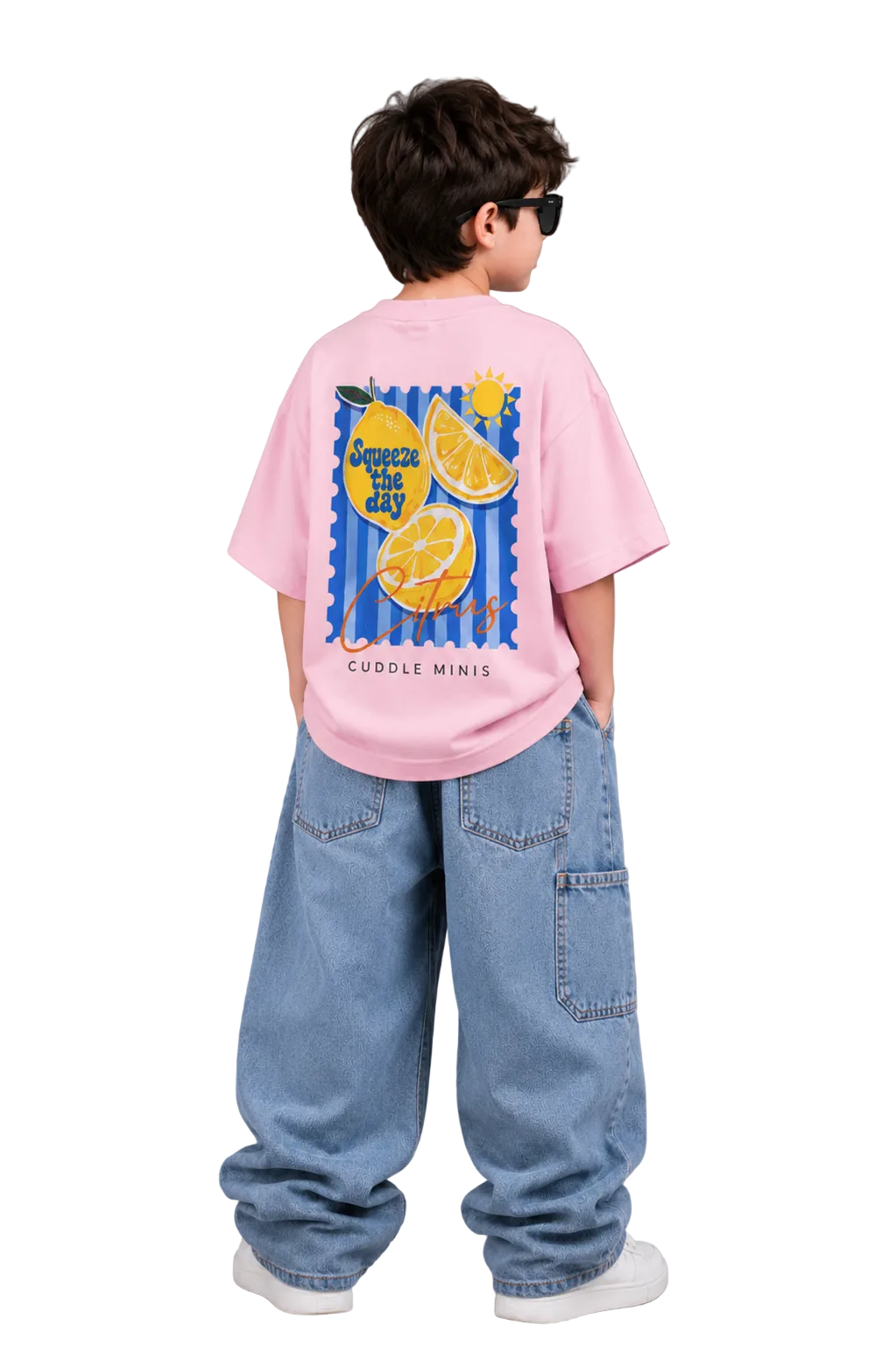 Child wearing a pink t-shirt with a lemon graphic and text, standing against a gray background