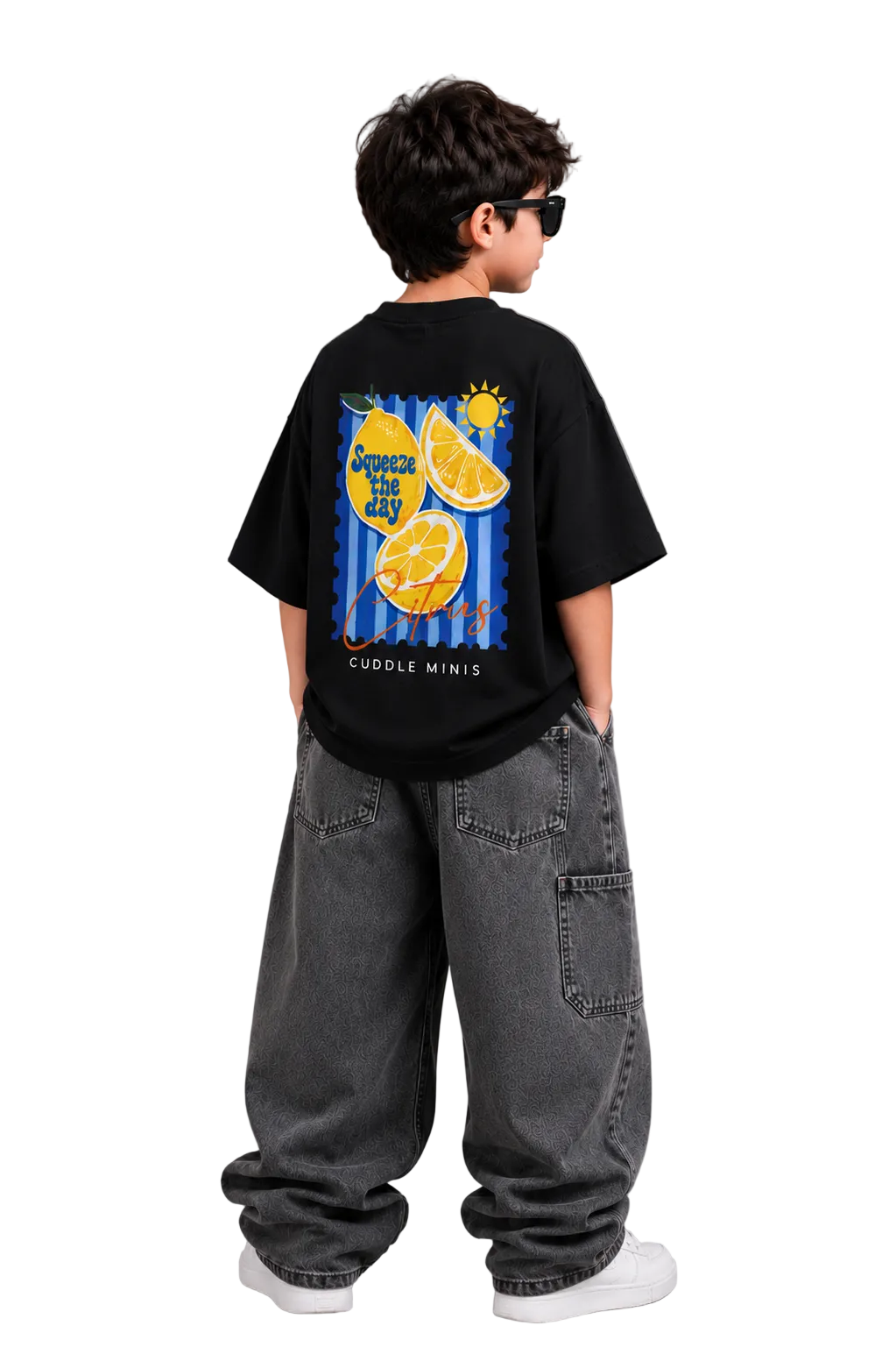 Child wearing a black t-shirt with a colorful design on the back, standing against a gray background.
