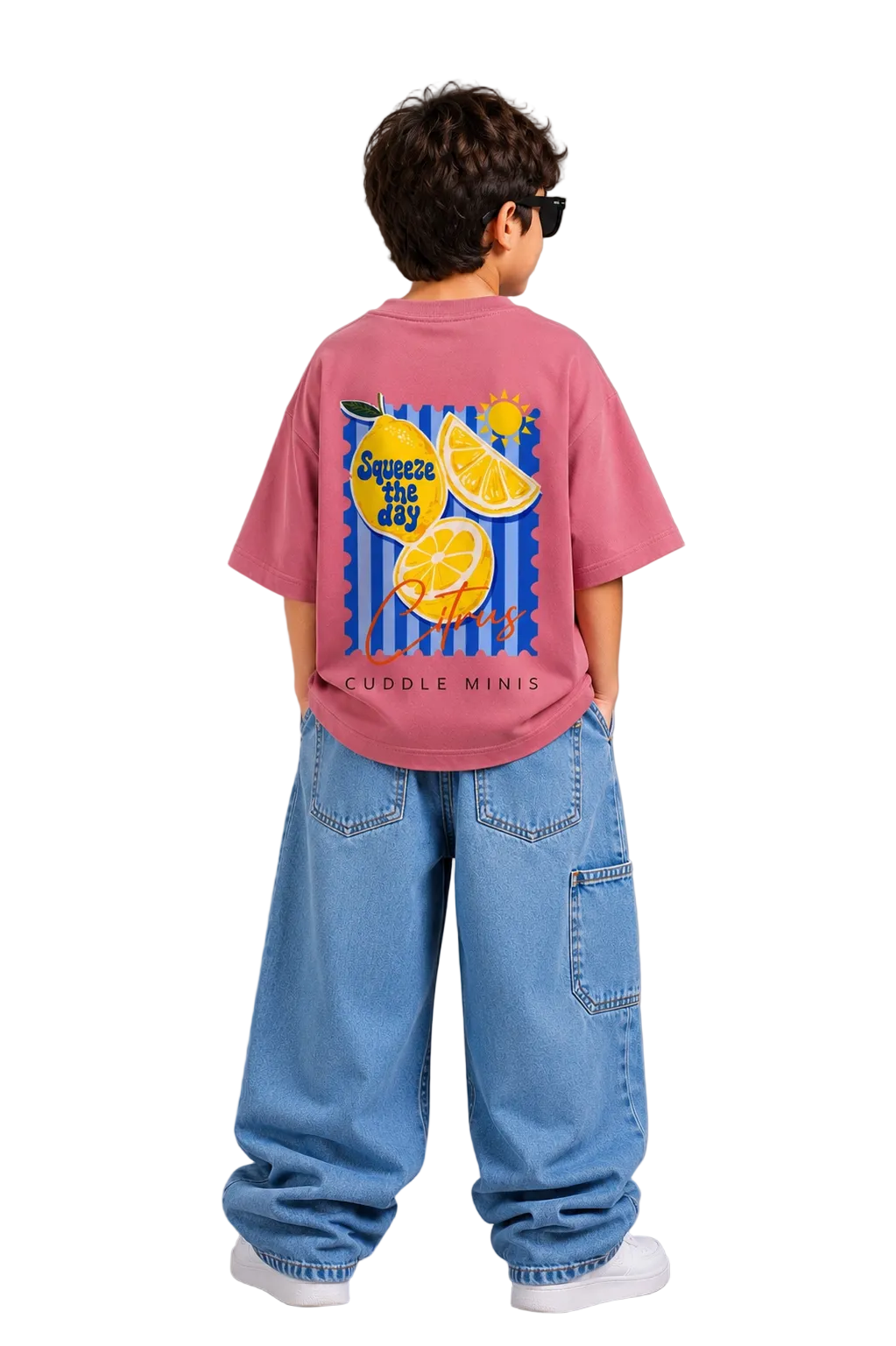 Child wearing a pink t-shirt with a lemon graphic and text, standing against a gray background
